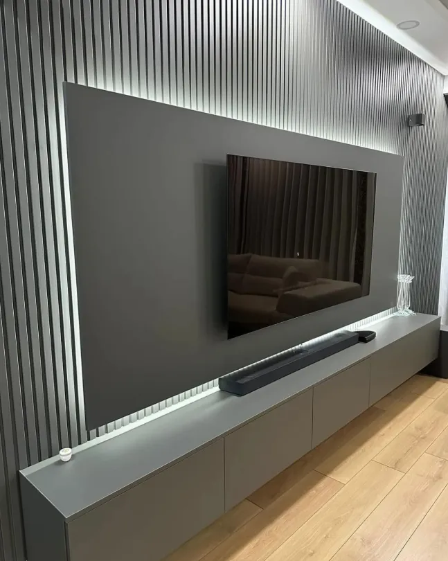 TV unit with modern wall slats by Finemark Cabinetry